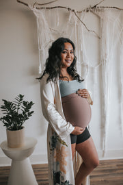 Young pregnant woman wearing in white floral kimono