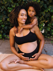 mom and baby sitting on yoga mat